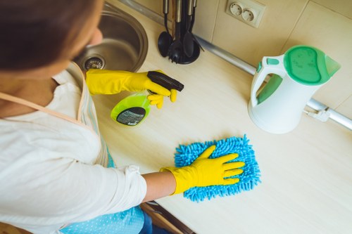 Professional builders cleaning in a Chelsea kitchen after refurbishment