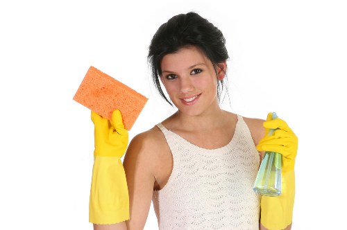 Professional carpet cleaners following health and safety controls during service