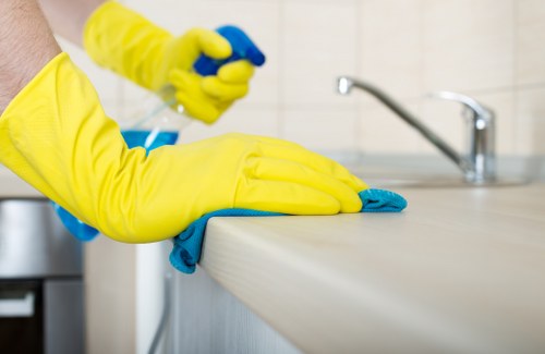 Kitchen surfaces being cleaned in a Chelsea move-in service